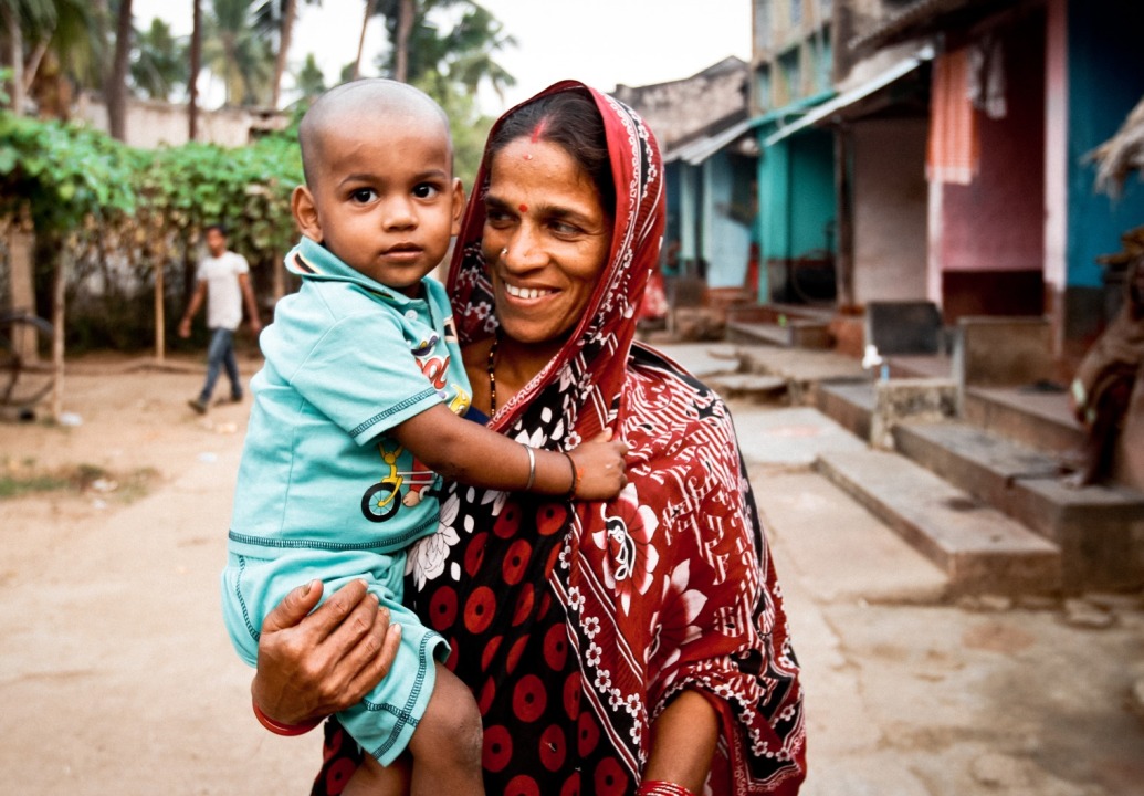 Mother-holding-child-in-village