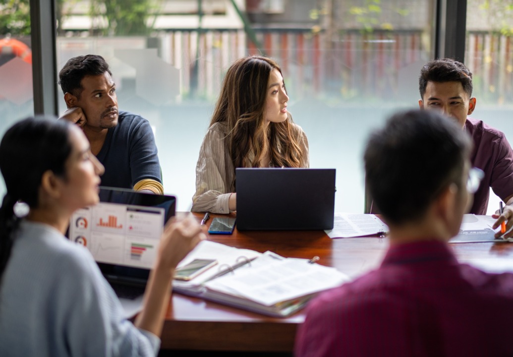 Group of people sitting around conference table