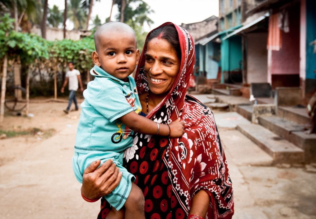 Mother-holding-child-in-village