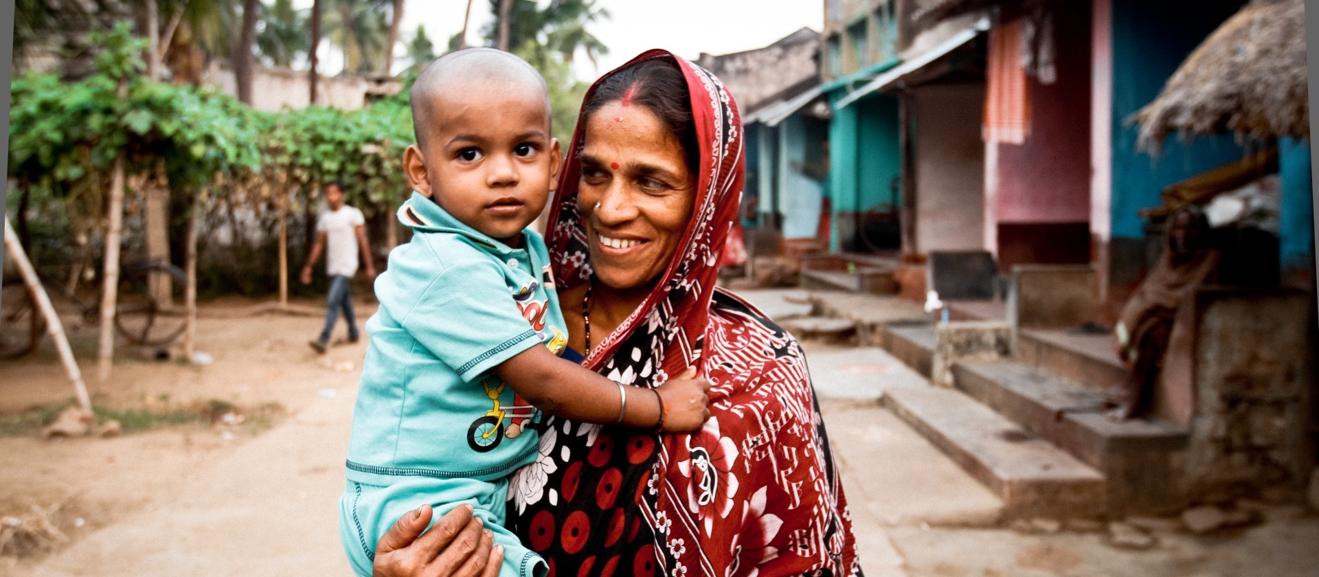 Mother-holding-child-in-village