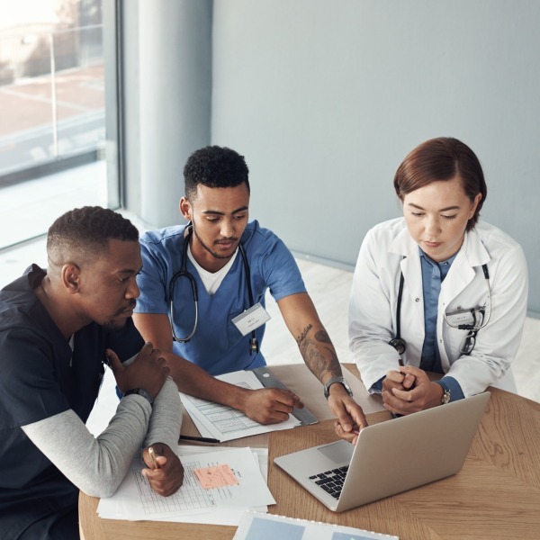 Medical professionals around a laptop